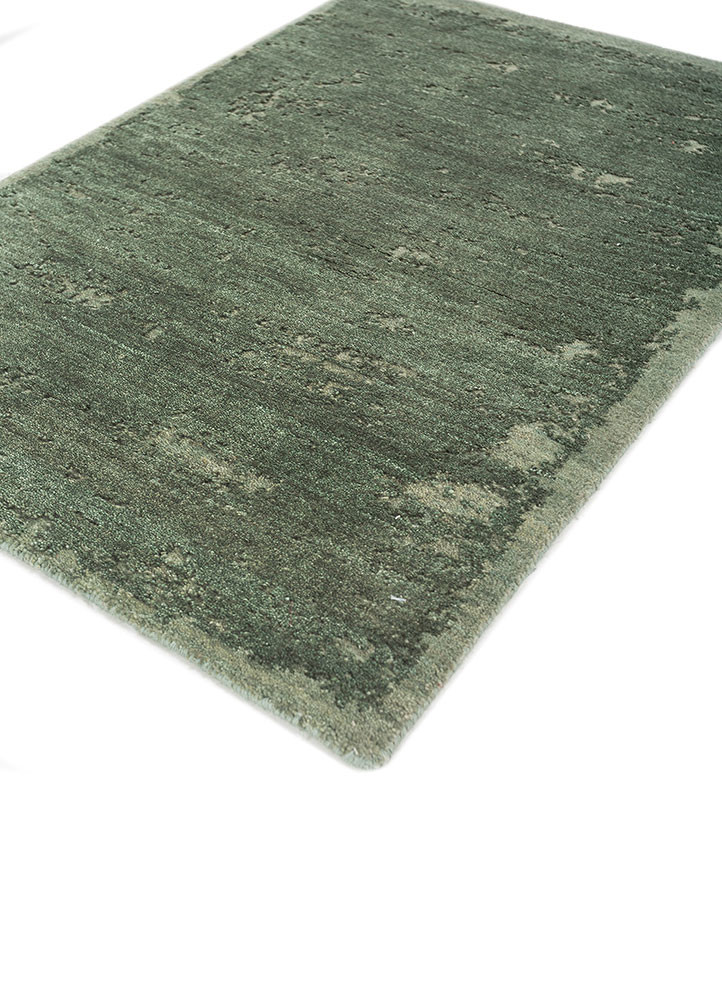 urban pause by kavi green wool hand knotted Rug - FoldShot urban pause by kavi green wool hand knotted Rug - FoldShot