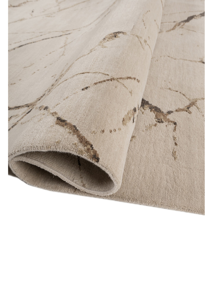 urban pause by kavi ivory wool and silk hand knotted Rug - FoldShot urban pause by kavi ivory wool and silk hand knotted Rug - FoldShot